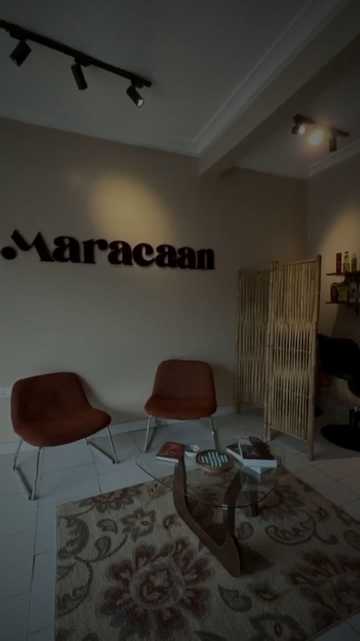 The Maracaan lounge with terracotta chairs beneath the studio wordmark